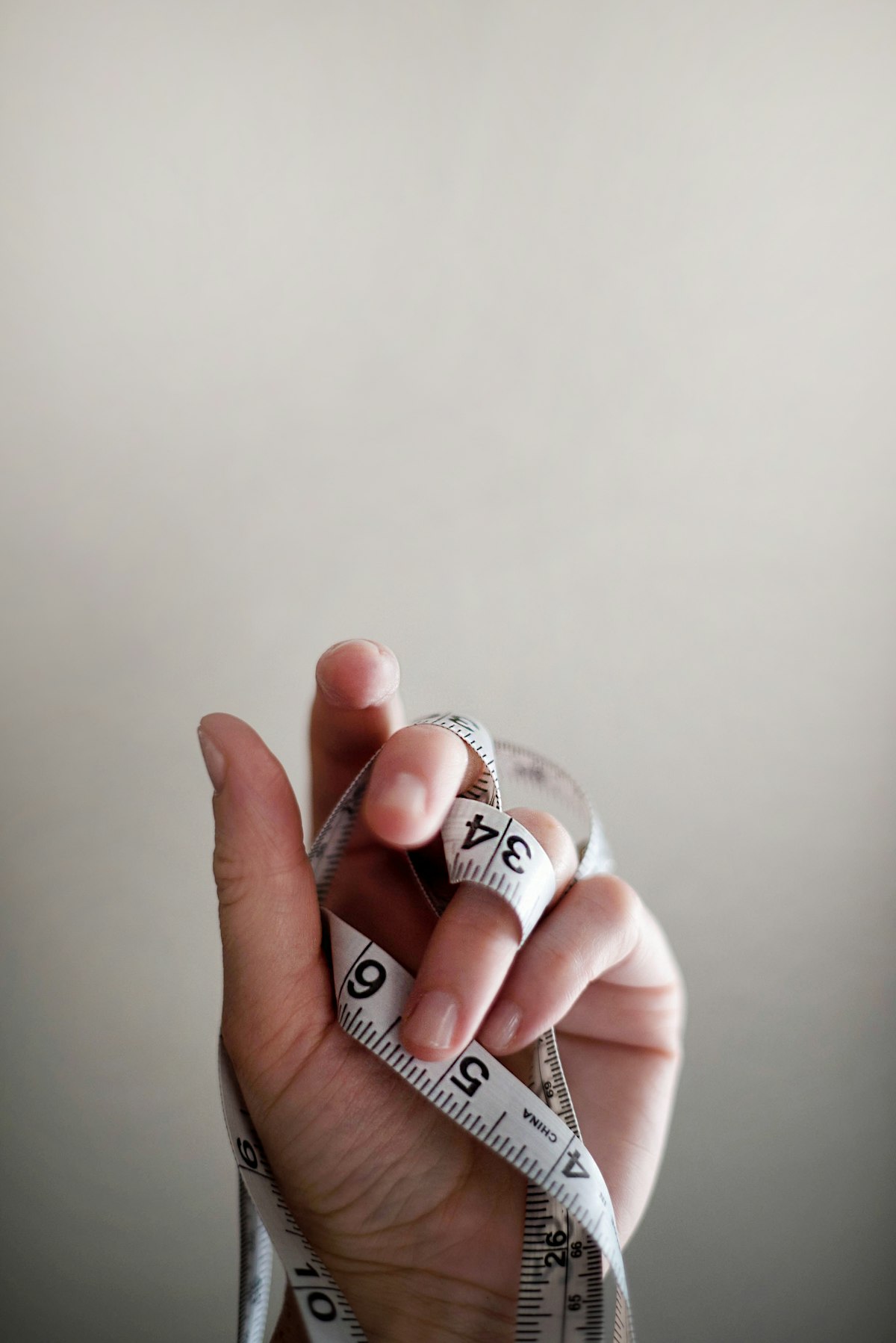 A hand holding a tape measure